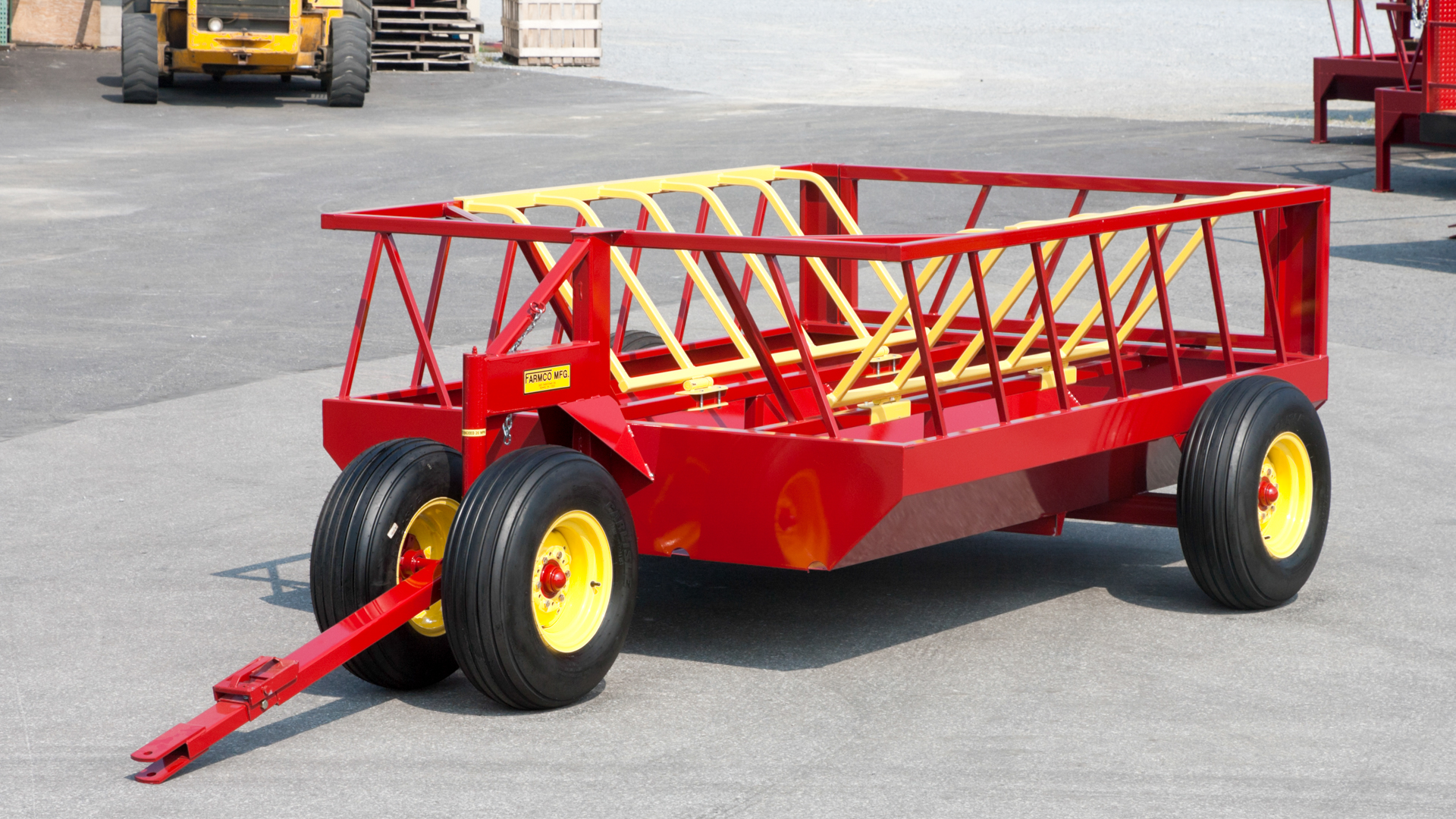 exterior of high quality red and yellow 700 drb feeder as example of best way to feed hay to cattle